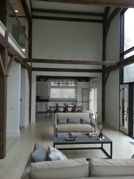 Interior, painted post and beam living room with vaulted ceilings.