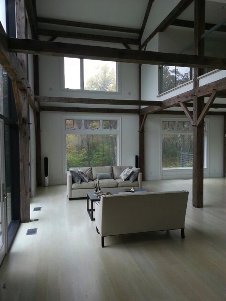 Living room of the post and beam house, with painted high walls.
